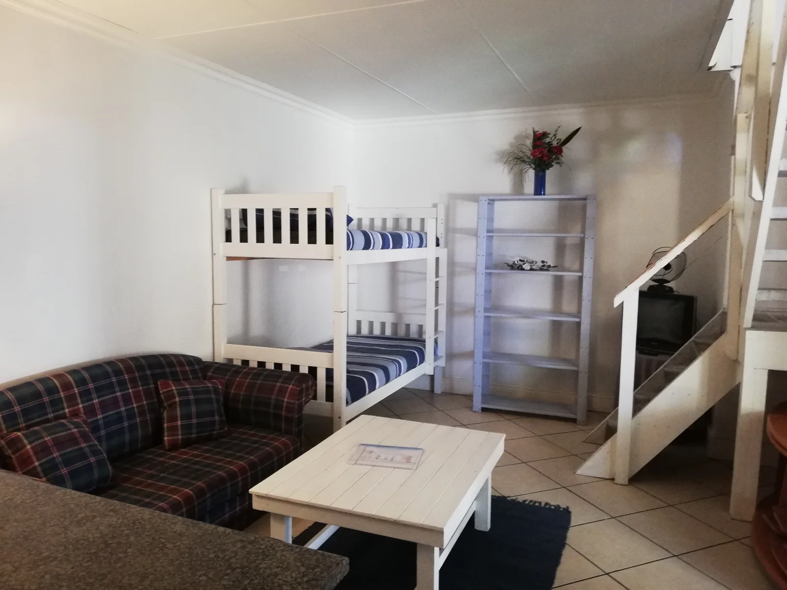 Self-catering space with a kitchenette, seating and bunk beds